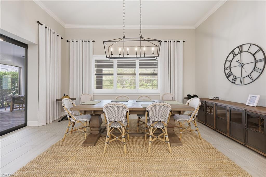 Dining room with ornamental molding and wood tiled floors