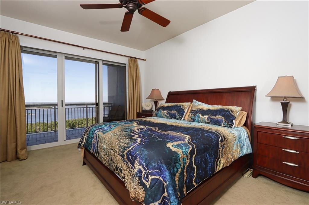Carpeted bedroom with access to exterior and ceiling fan