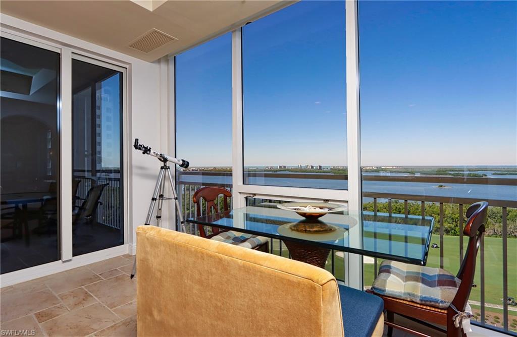 Sunroom featuring a water view