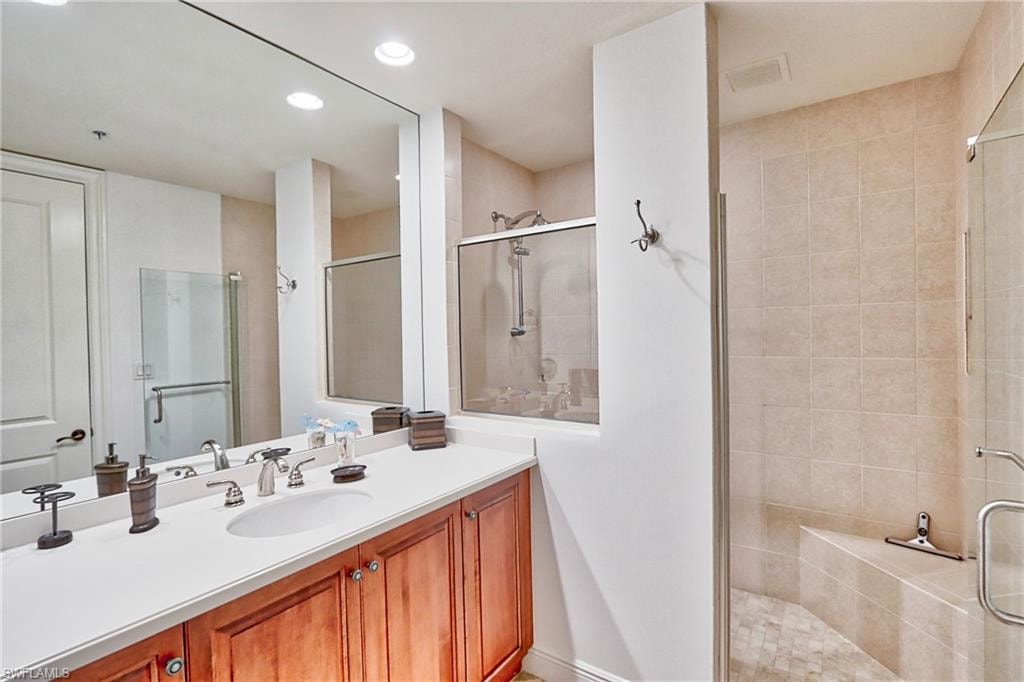 Bathroom featuring vanity and an enclosed shower