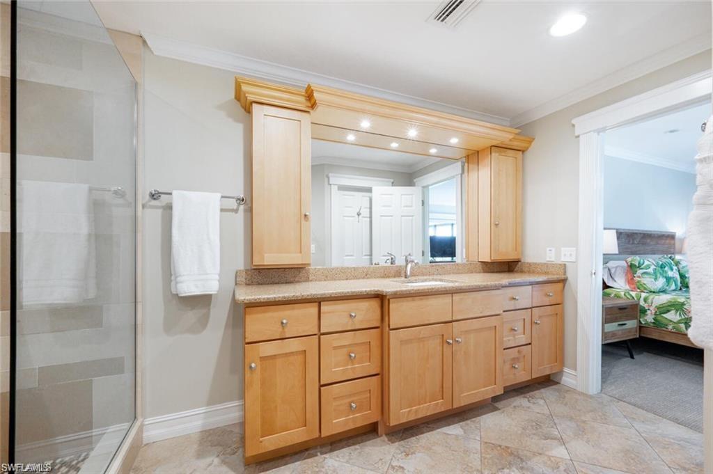 Carpeted 2nd bedroom with ceiling fan, crown molding, and walkout access to outside
