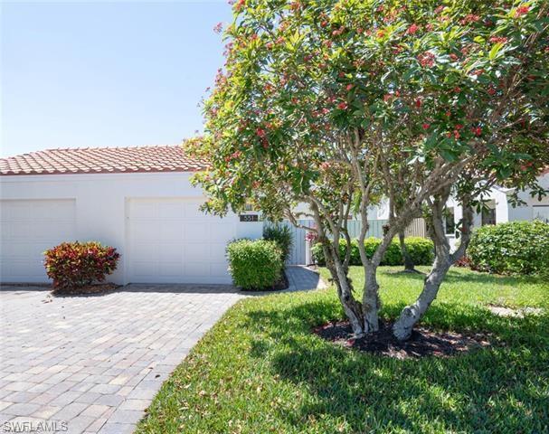 View of front of home featuring a garage and a front lawn