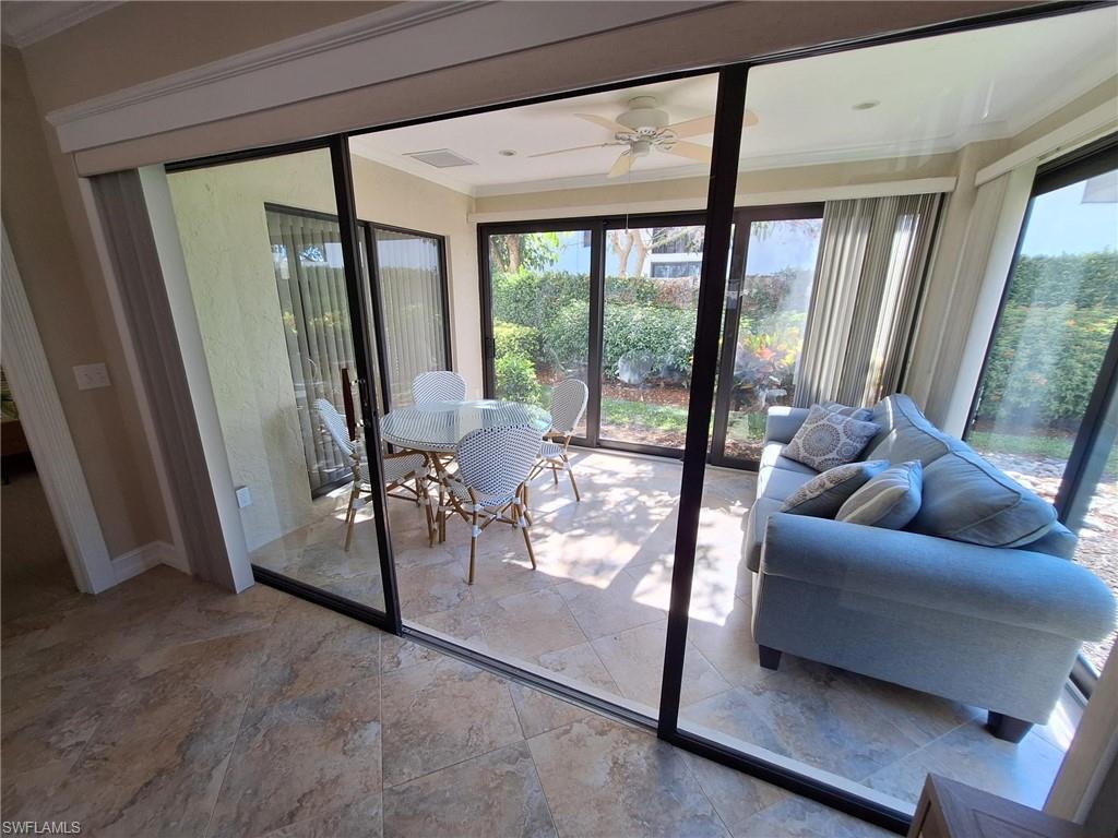 Sunroom / solarium with a healthy amount of sunlight and ceiling fan