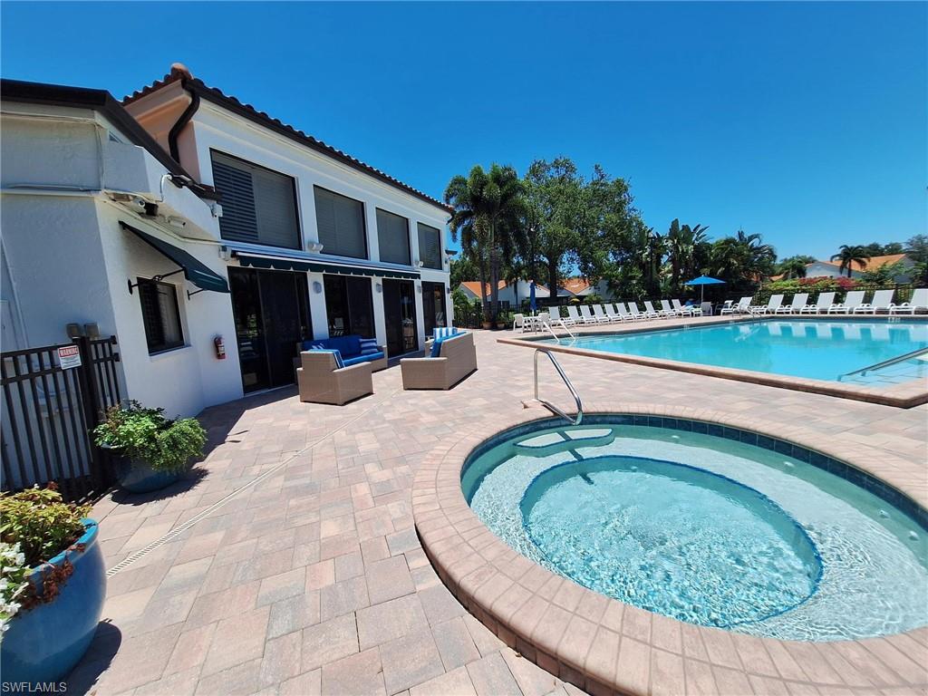 View of swimming pool with outdoor lounge and spa area, a patio area, and a hot tub
