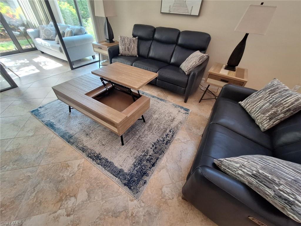 Living room featuring tile floors and pop coffee table desk