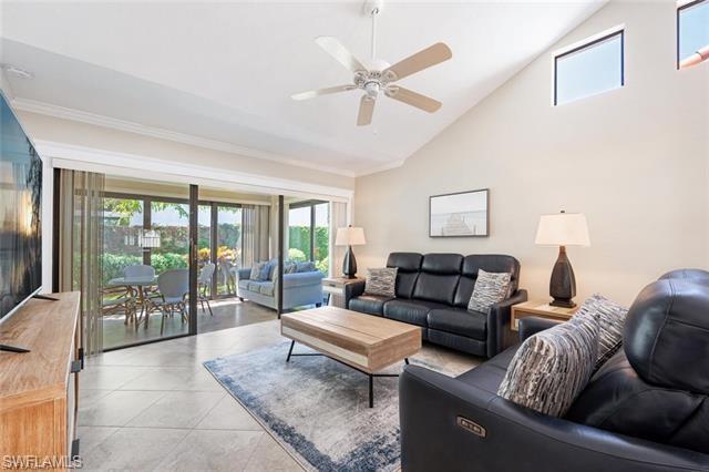 Tiled living room, high vaulted ceiling, ceiling fan and motorized sofas.