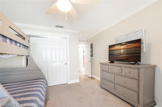 Primary Bathroom featuring walk in shower, vanity, tile floors, and crown molding