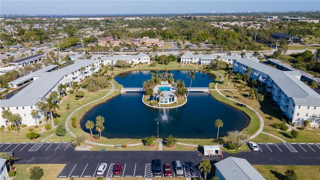 Waterfront community featuring multiple buildings, paved parking areas, and mature landscaping
