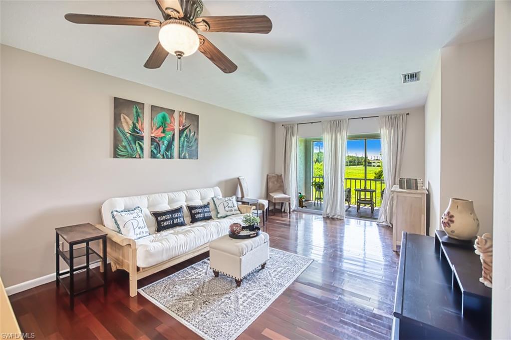 Living area with wood finished floors and ceiling fan