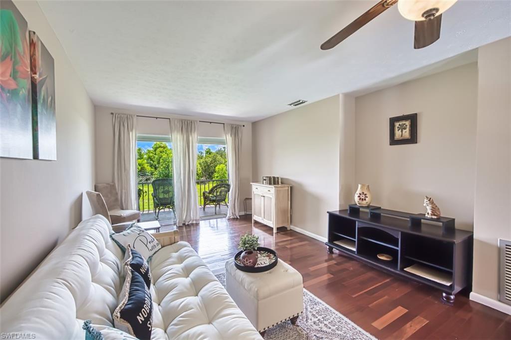 Living room featuring a ceiling fan and wood finished floors
