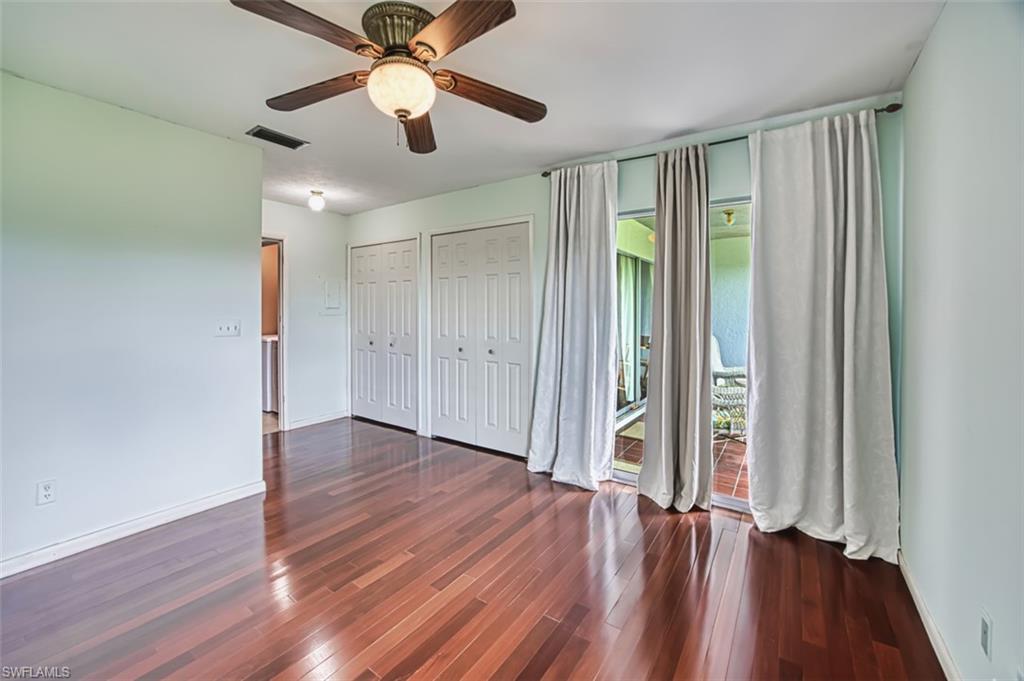 Unfurnished bedroom featuring two closets, hardwood / wood-style flooring, and ceiling fan