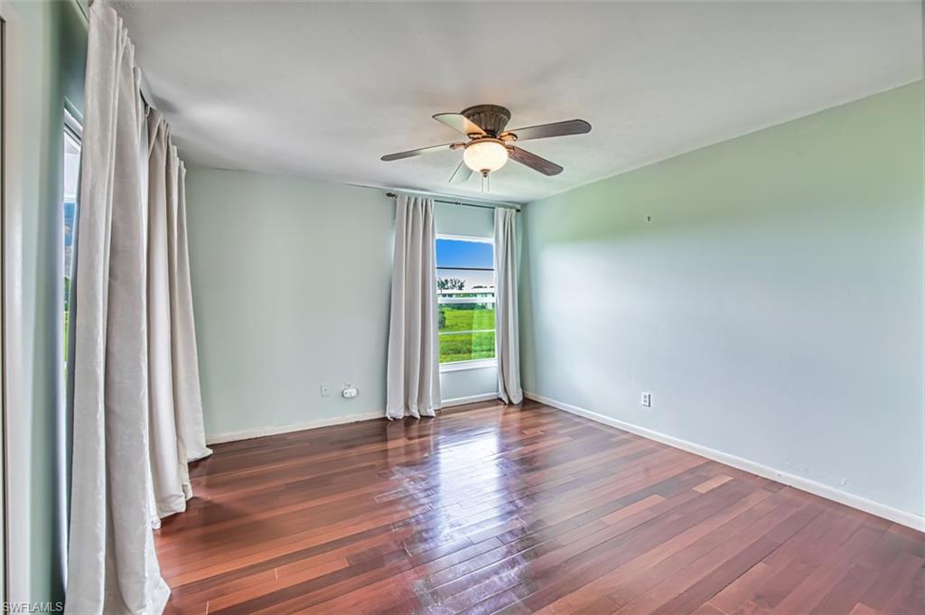 Empty room with a ceiling fan and wood-type flooring