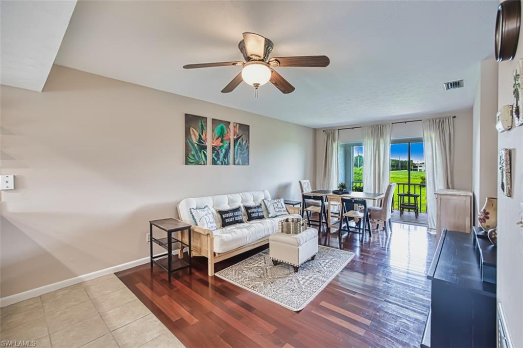 Living room with ceiling fan and wood finished floors