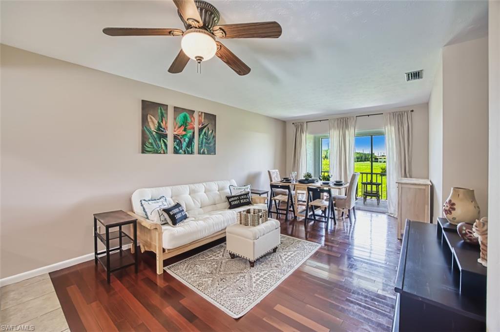 Living area featuring wood finished floors and ceiling fan