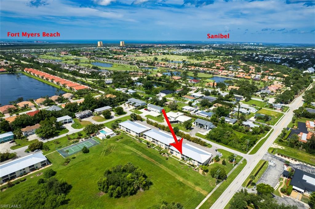 View of property location featuring a nearby body of water and nearby suburban area