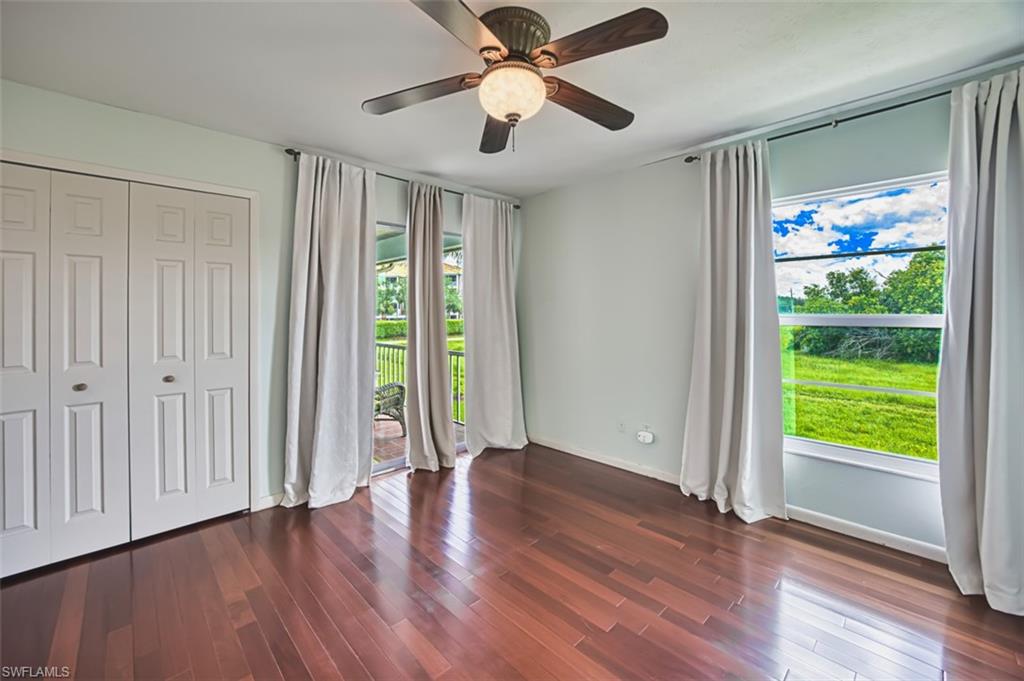 Unfurnished bedroom featuring dark wood finished floors, ceiling fan, and a closet