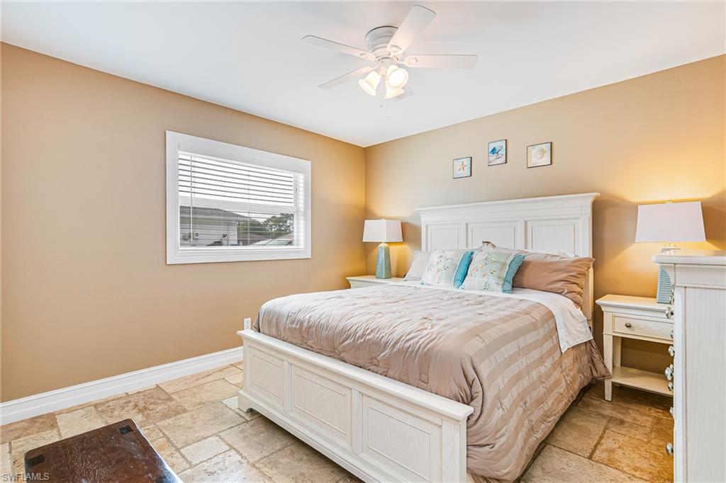 Spacious room featuring neutral wall tones and large format tile flooring - Virtually Edited Image