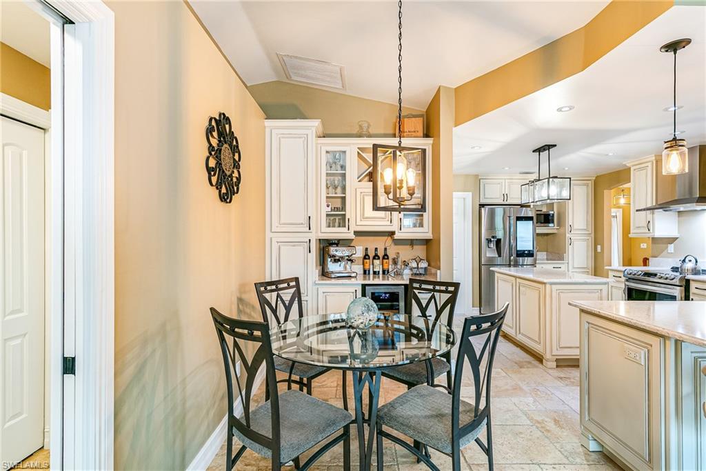 Dining area with tile flooring and a glass-top table - Virtually Edited Image