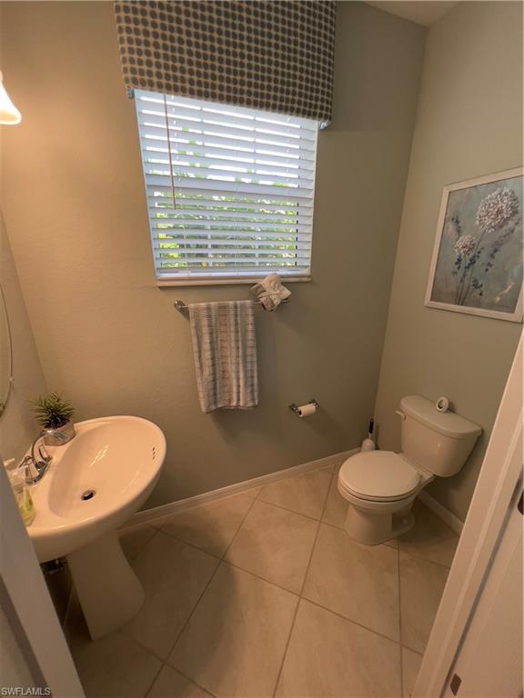 Bathroom featuring toilet and tile patterned flooring