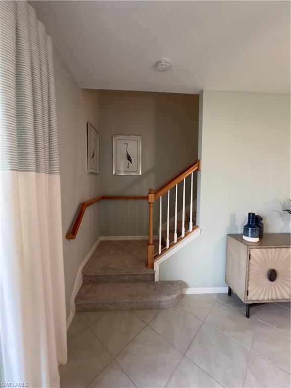 Staircase with tile patterned flooring