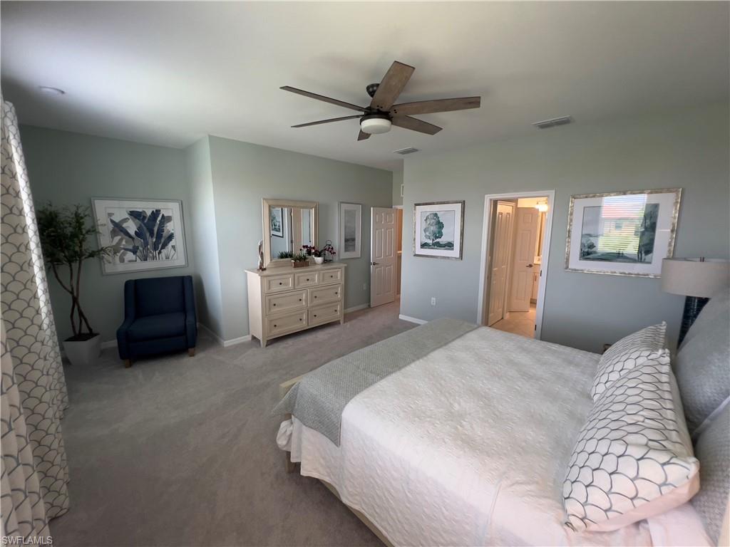 Carpeted bedroom with ceiling fan