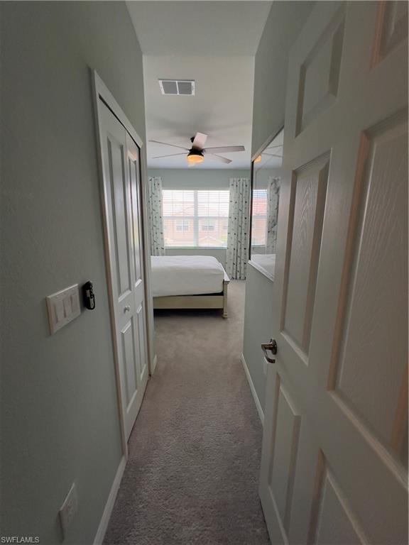 Hallway featuring carpet flooring