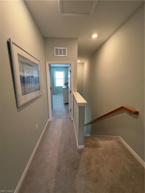 Hallway featuring carpet flooring