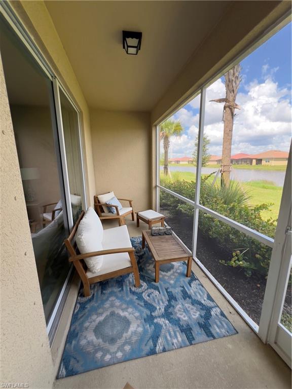 Sunroom with a water view and plenty of natural light