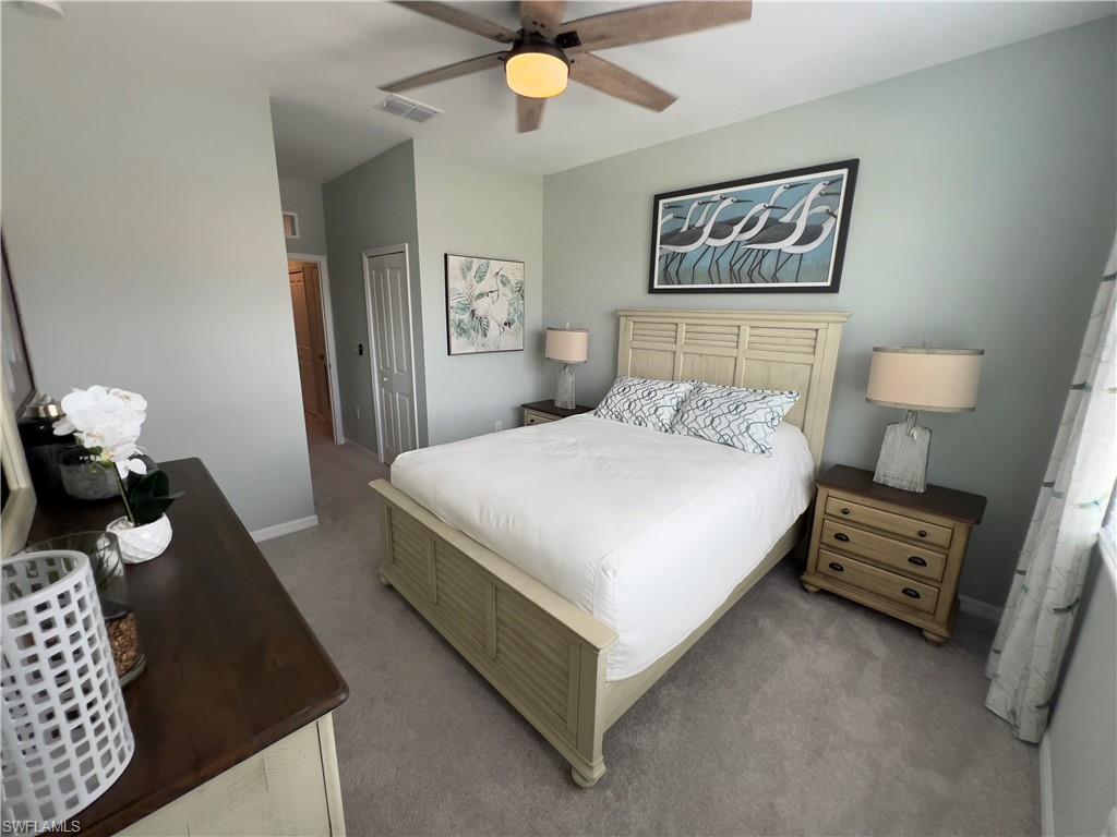 Bedroom featuring carpet floors, ceiling fan, and a closet