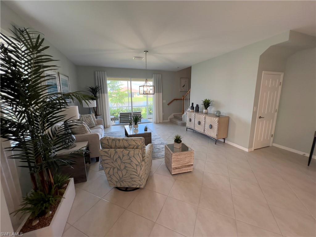 Tiled living room with a notable chandelier