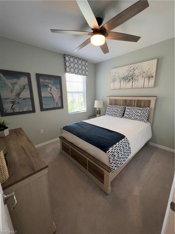 Carpeted bedroom with ceiling fan