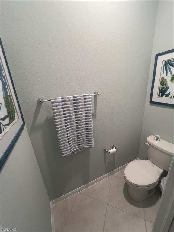 Bathroom featuring tile patterned flooring and toilet