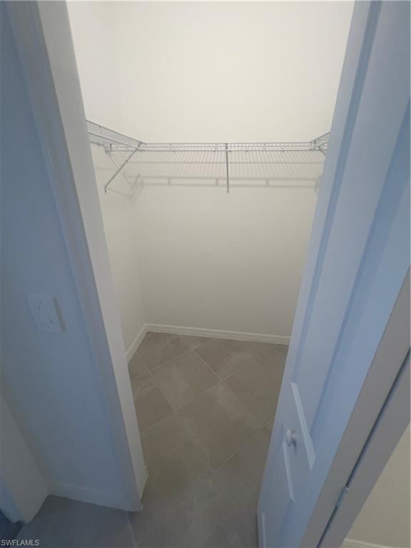 Spacious closet with tile patterned floors