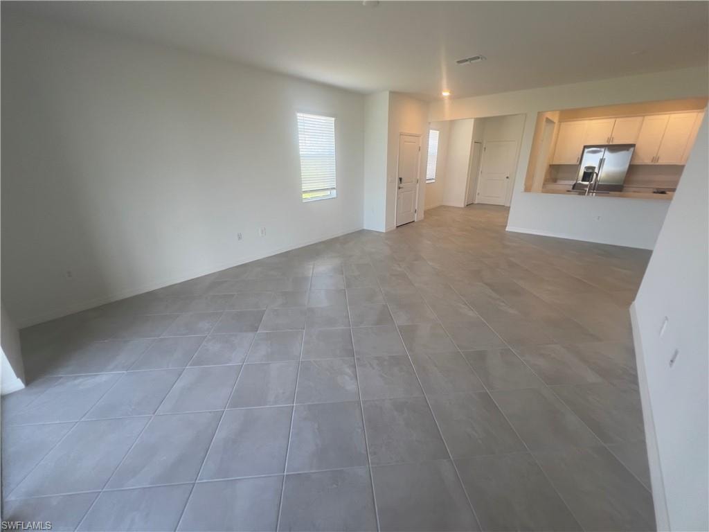 Unfurnished living room with tile patterned floors
