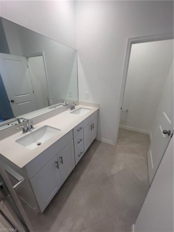 Bathroom featuring tile patterned flooring and vanity
