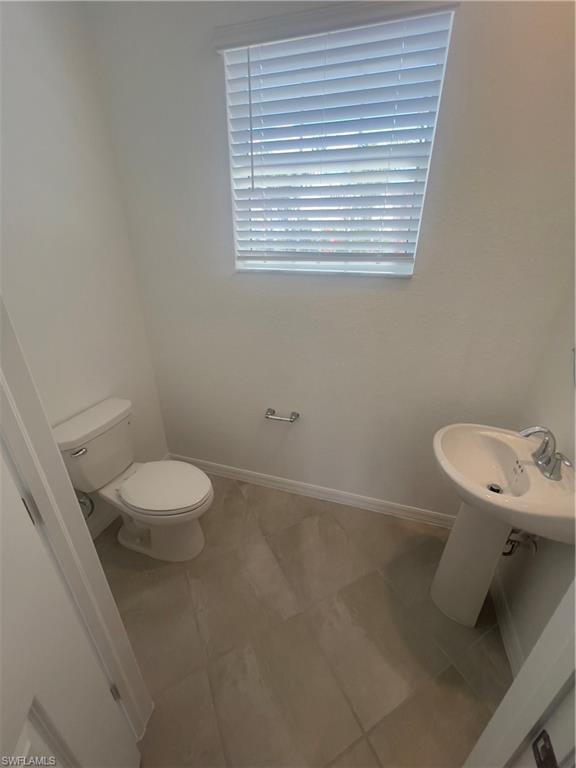 Bathroom featuring tile patterned floors and toilet