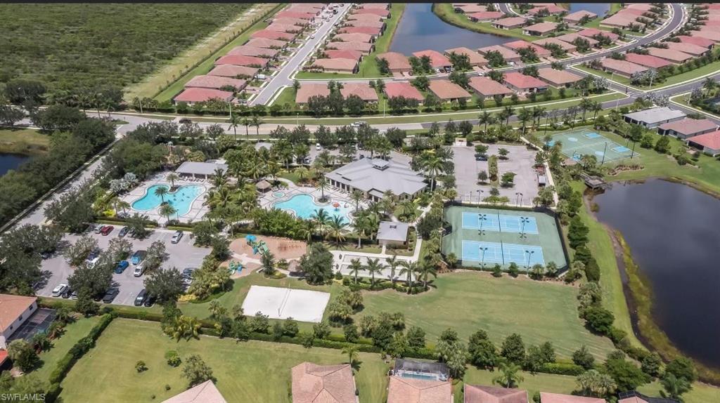 Birds eye view of property with a water view