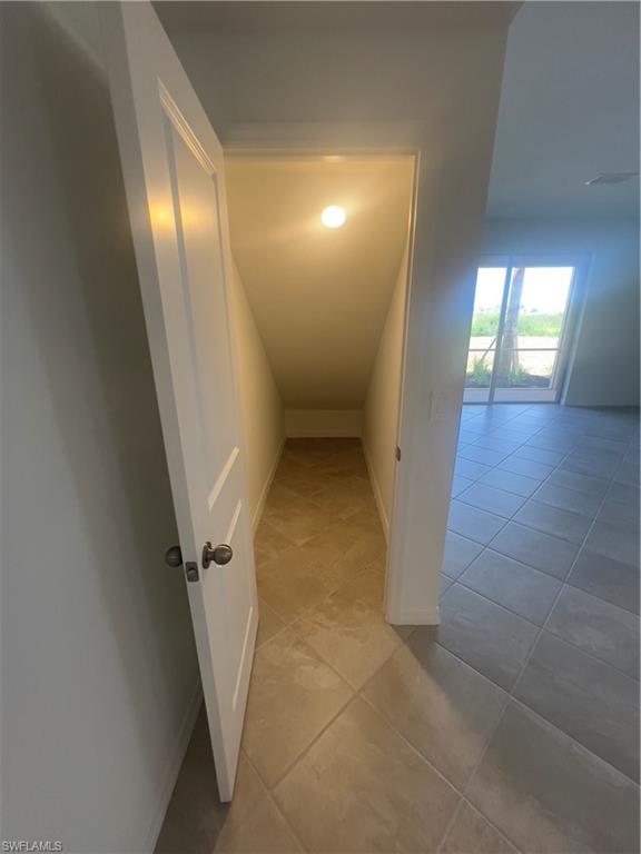 Hallway with light tile patterned floors