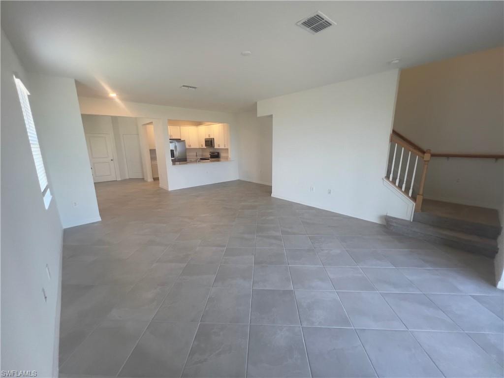 Unfurnished living room featuring tile patterned flooring