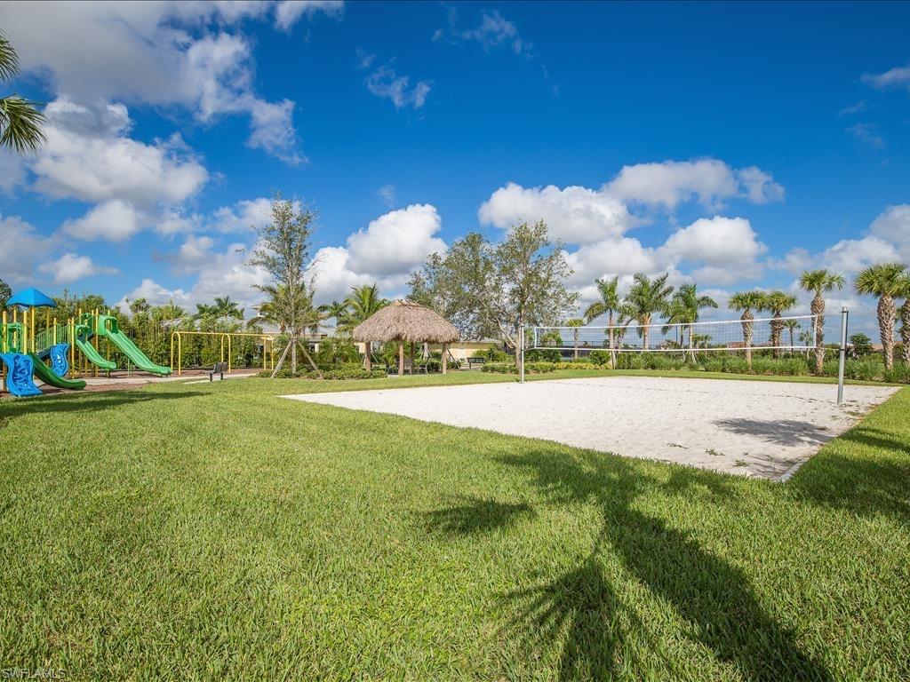 View of community with volleyball court, a gazebo, a playground, and a lawn