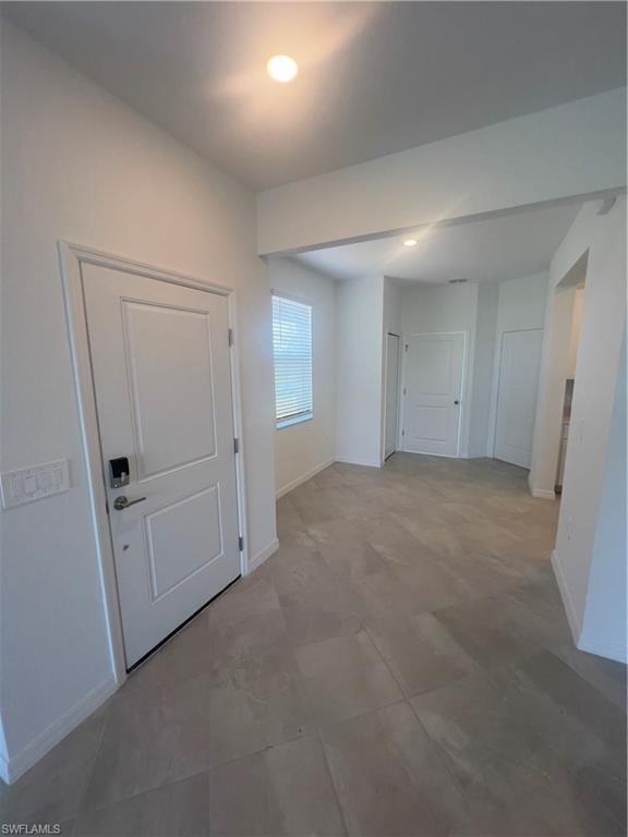 Hallway featuring tile patterned floors