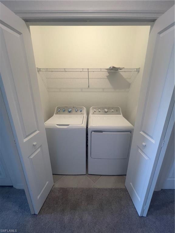 Washroom featuring carpet flooring and washer and dryer