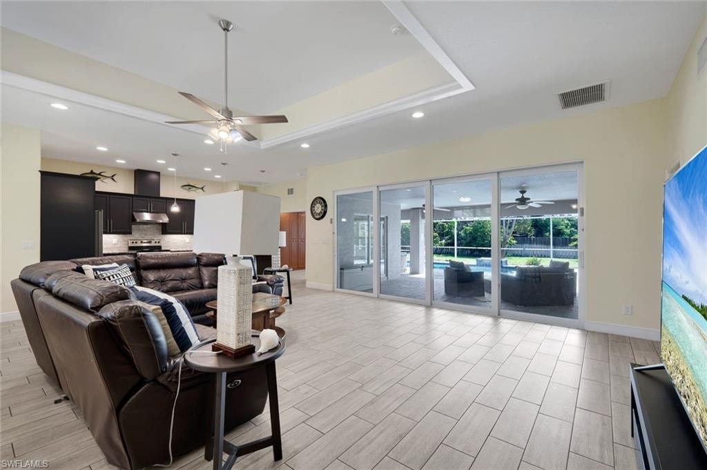 Open-concept living space featuring wood-finish tile flooring and recessed lighting