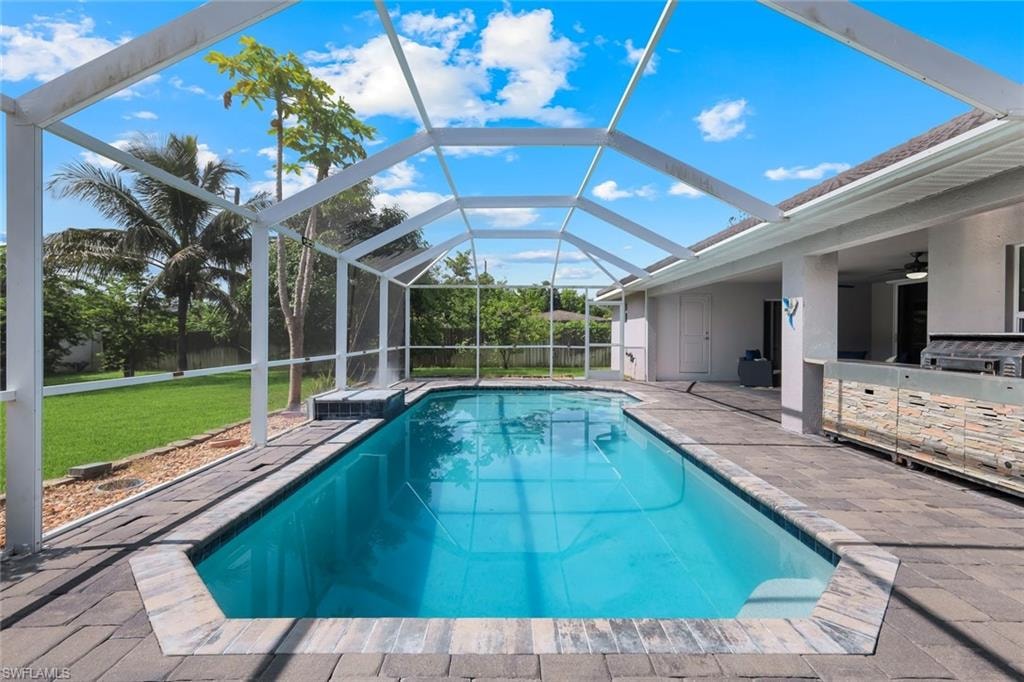 Screened-in swimming pool with paver decking