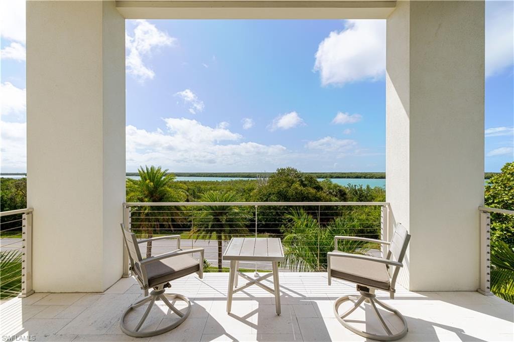 Spacious outdoor balcony with tile flooring and a cable railing system