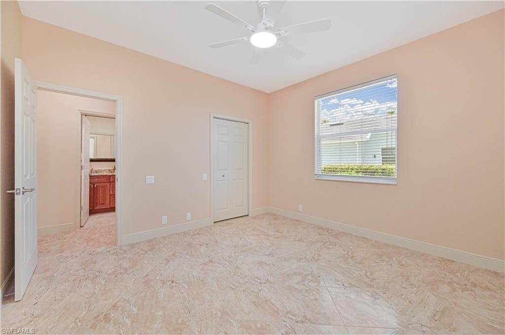 Spacious room with large-format tile flooring, a ceiling fan with integrated lighting, and a window featuring blinds