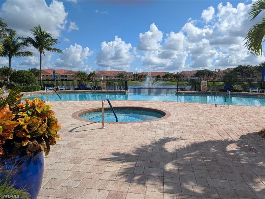 Community pool featuring a community hot tub and a residential view
