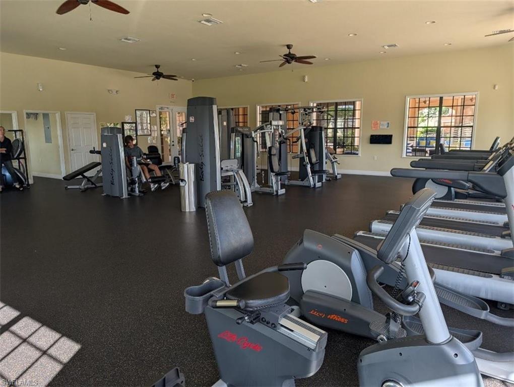 Exercise room with a ceiling fan and recessed lighting