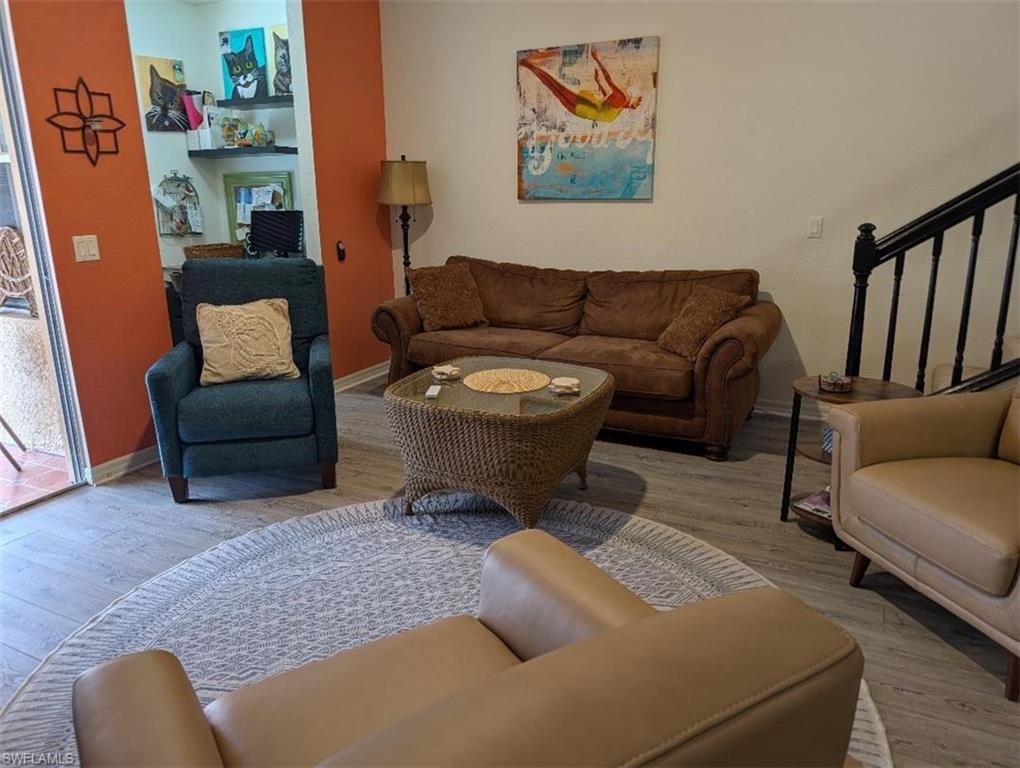 Living area featuring stairs and wood finished floors