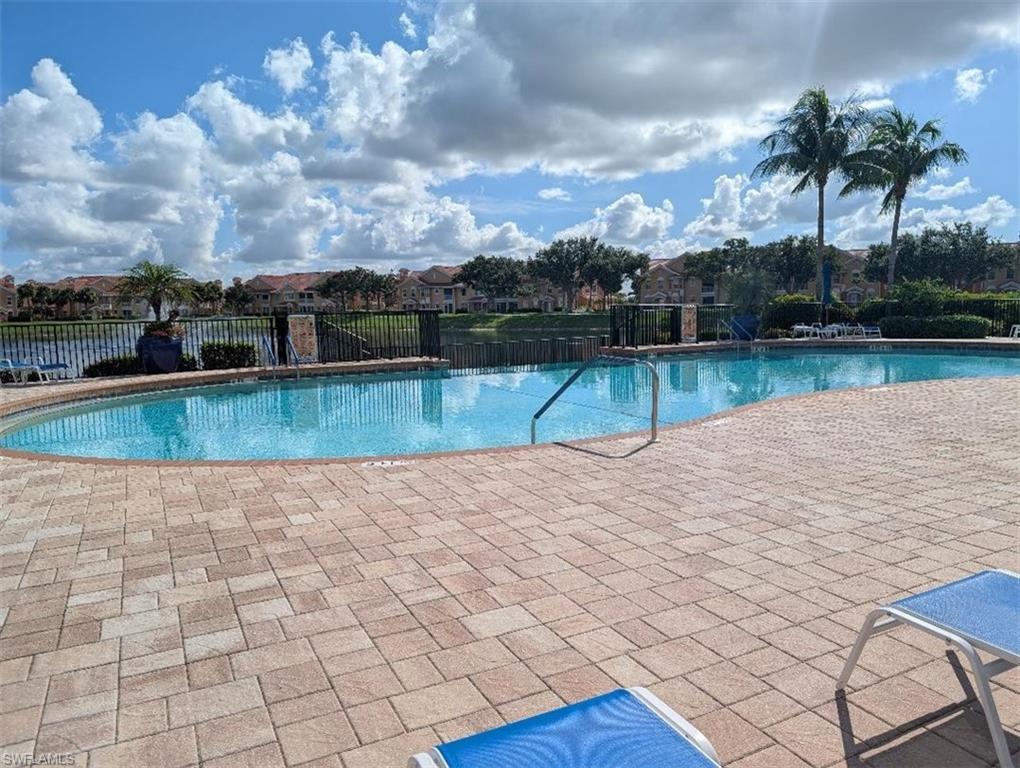 Community pool featuring a patio and a residential view